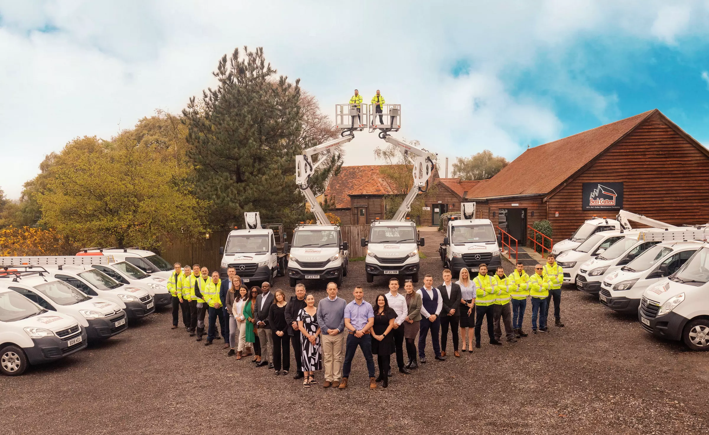 Photo of all Ben's Gutters Commercial staff and vehicles.