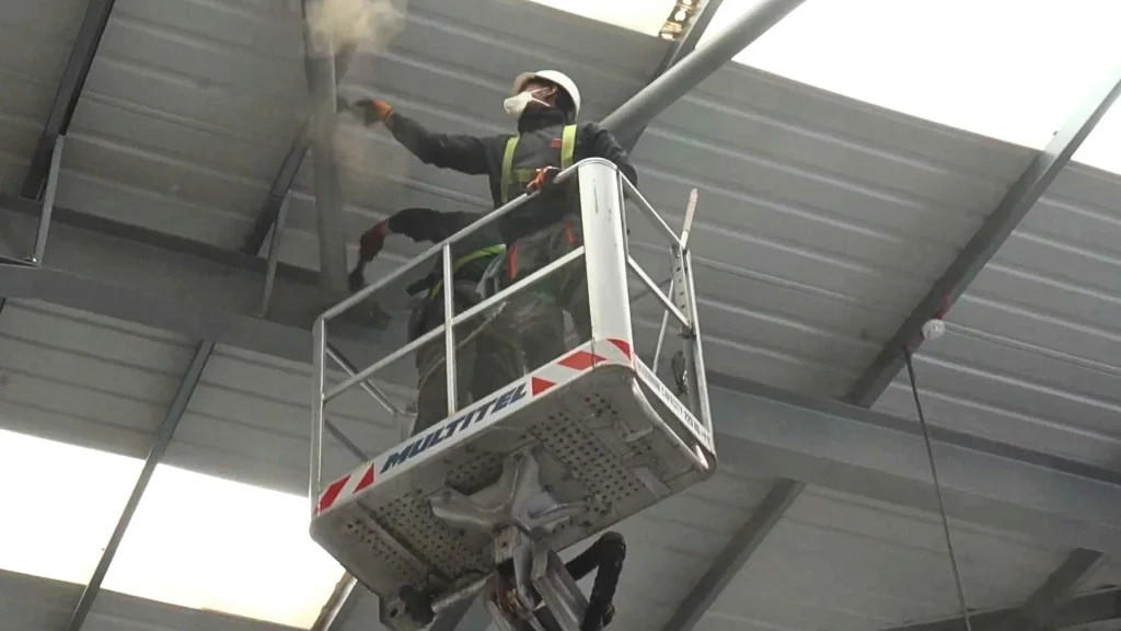 Cleaners dealing with dust in commercial warehouse