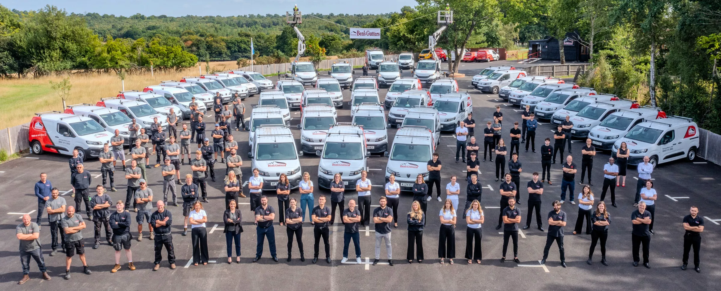 Photo of all Ben's Gutters Commercial staff and vehicles.